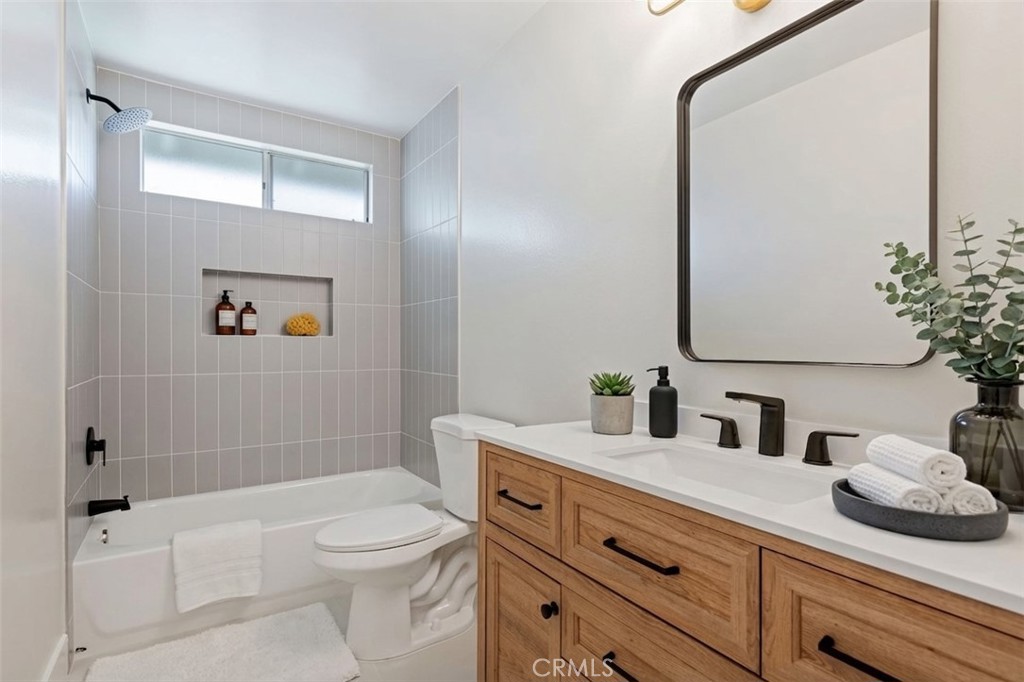 1077 Offshore Street Oxnard, CA 93035 - Photo 19 of 33 a bathroom with a sink a toilet and shower