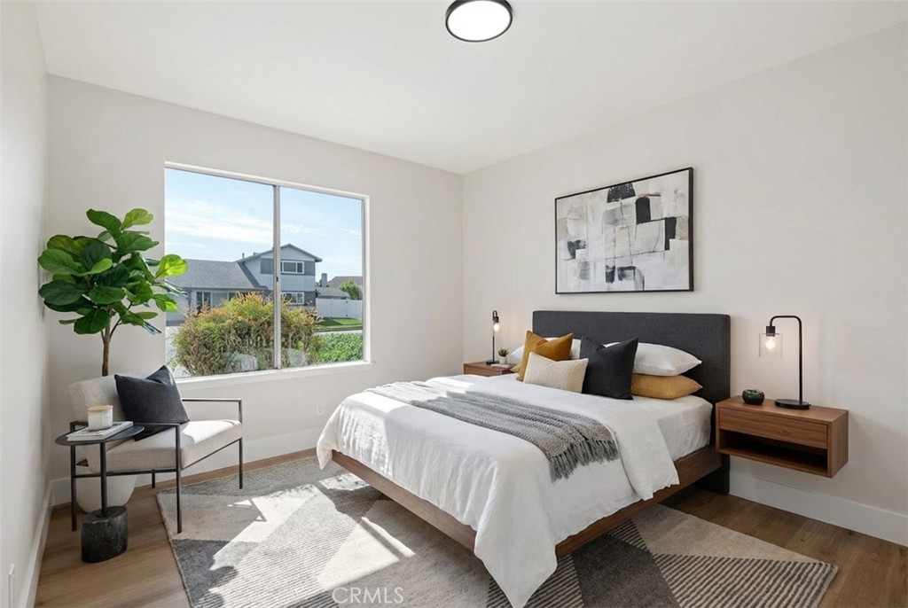 1077 Offshore Street Oxnard, CA 93035 - Photo 24 of 33 a bedroom with a bed a plant and a window