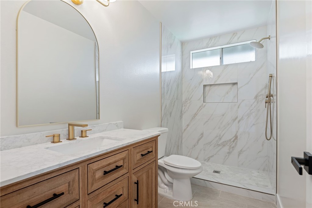 1077 Offshore Street Oxnard, CA 93035 - Photo 25 of 33 a bathroom with a sink a toilet and shower