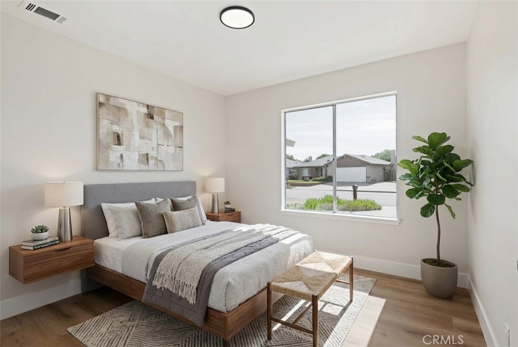 1077 Offshore Street Oxnard, CA 93035 - Photo 28 of 33 a bedroom with a bed potted plant with the window