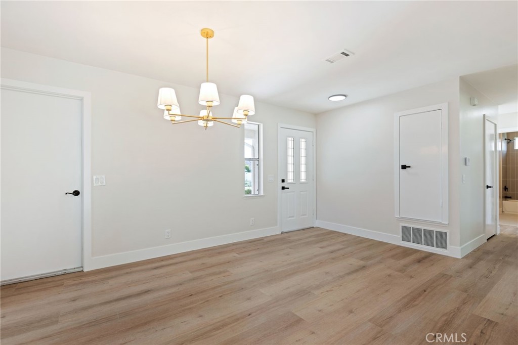 1077 Offshore Street Oxnard, CA 93035 - Photo 4 of 33 a view of empty room with wooden floor and ceiling fan