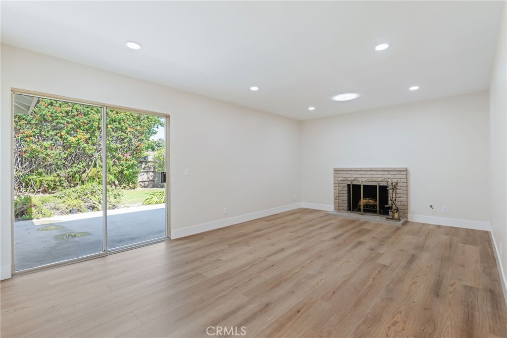 1077 Offshore Street Oxnard, CA 93035 - Photo 10 of 33 an empty room with large windows and a fireplace