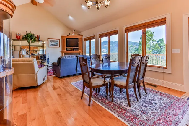 a dining room with furniture and wooden floor