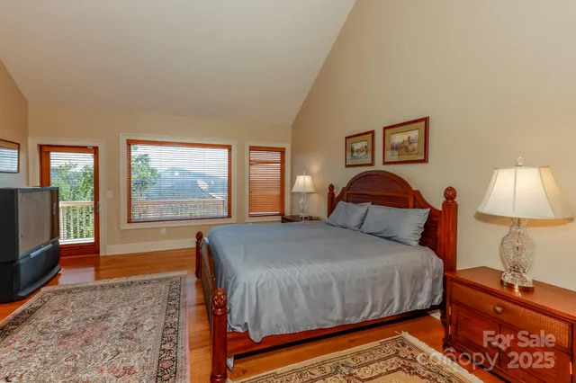 a bedroom with a bed and a lamp on dresser
