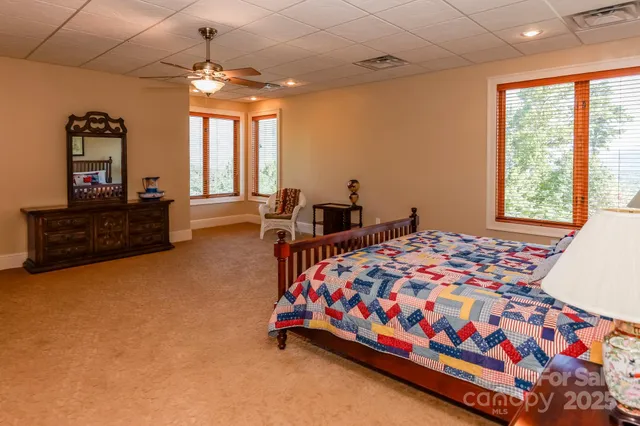 a bed sitting in a bedroom next to a window