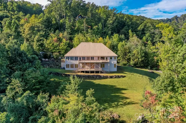 a view of a house with a yard and swimming pool