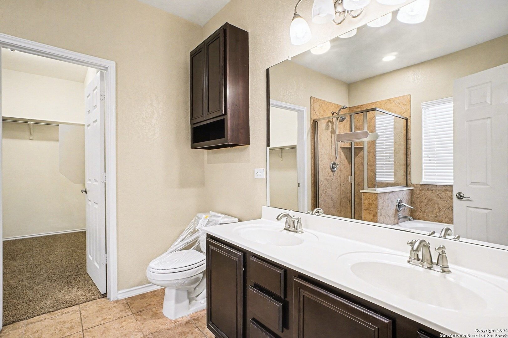 136 Prairie Falcon Boerne, TX 78006 - Photo 13 of 26 a bathroom with a sink a toilet a mirror and shower