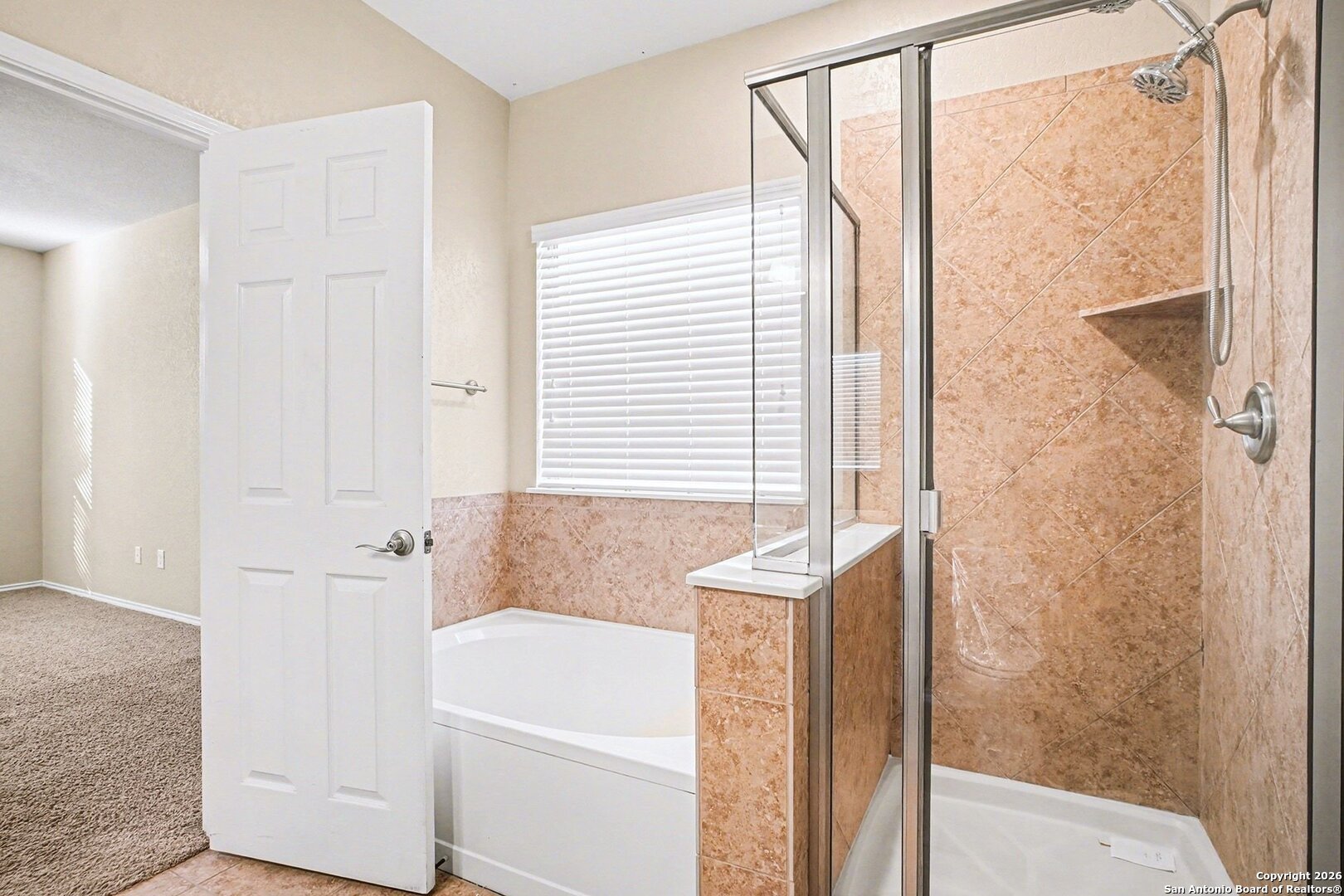 136 Prairie Falcon Boerne, TX 78006 - Photo 14 of 26 a bathroom with a bathtub and a shower