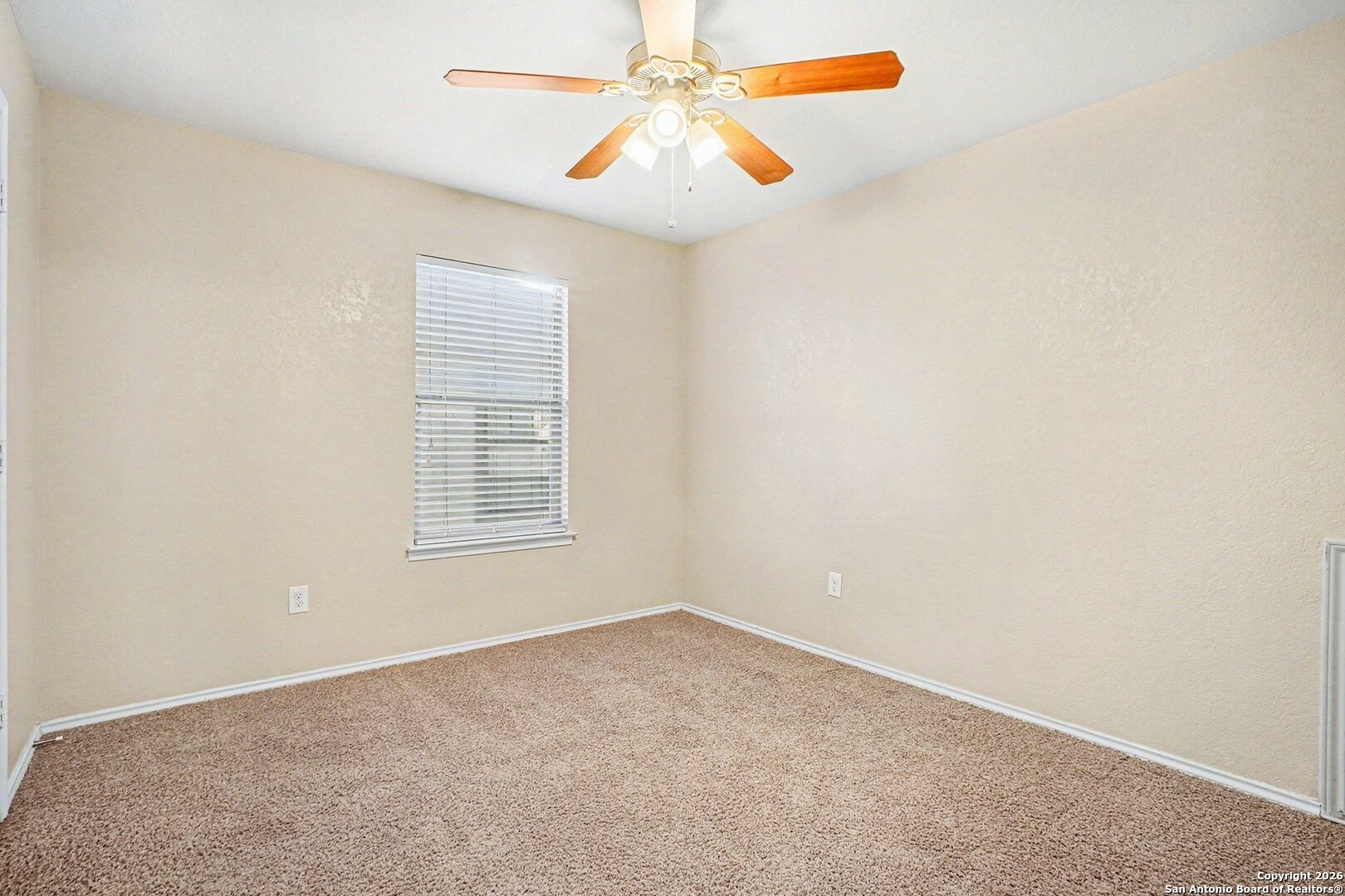 136 Prairie Falcon Boerne, TX 78006 - Photo 15 of 26 an empty room with chandelier fan and window
