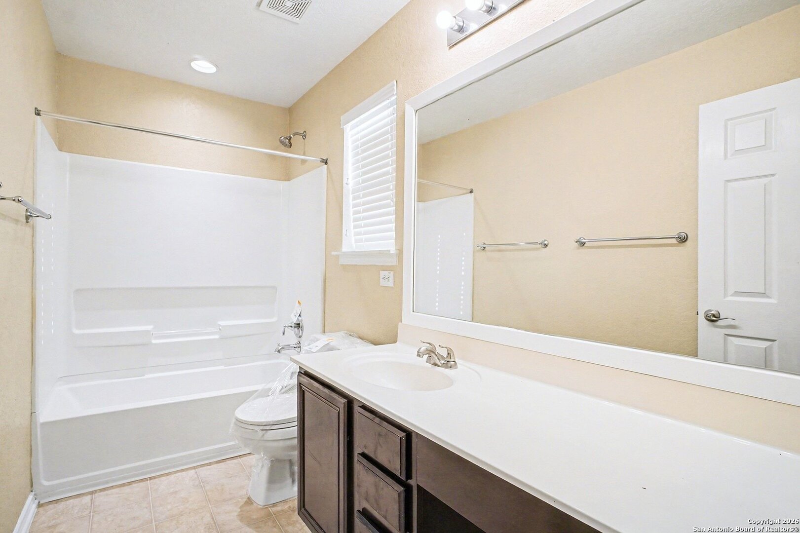 136 Prairie Falcon Boerne, TX 78006 - Photo 19 of 26 a bathroom with a bathtub shower sink vanity and a toilet