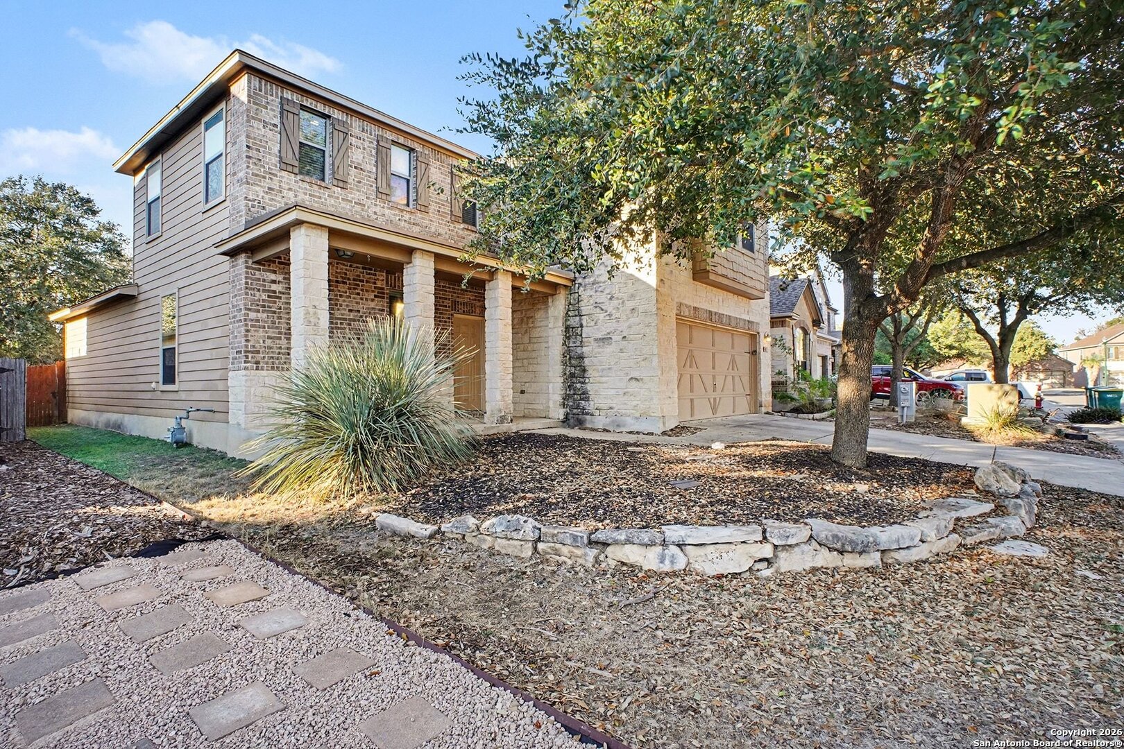 136 Prairie Falcon Boerne, TX 78006 - Photo 2 of 26 a front view of a house with a garden