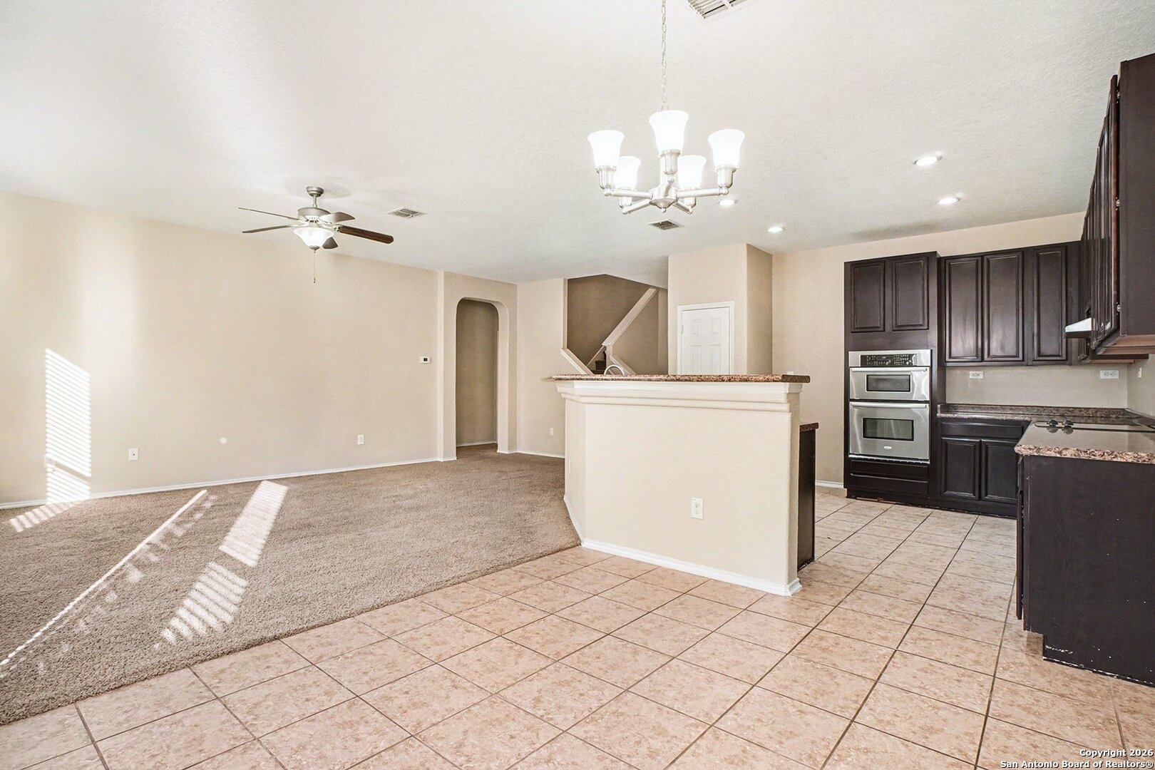 136 Prairie Falcon Boerne, TX 78006 - Photo 6 of 26 a view of a kitchen with a sink and dishwasher a refrigerator with white cabinets
