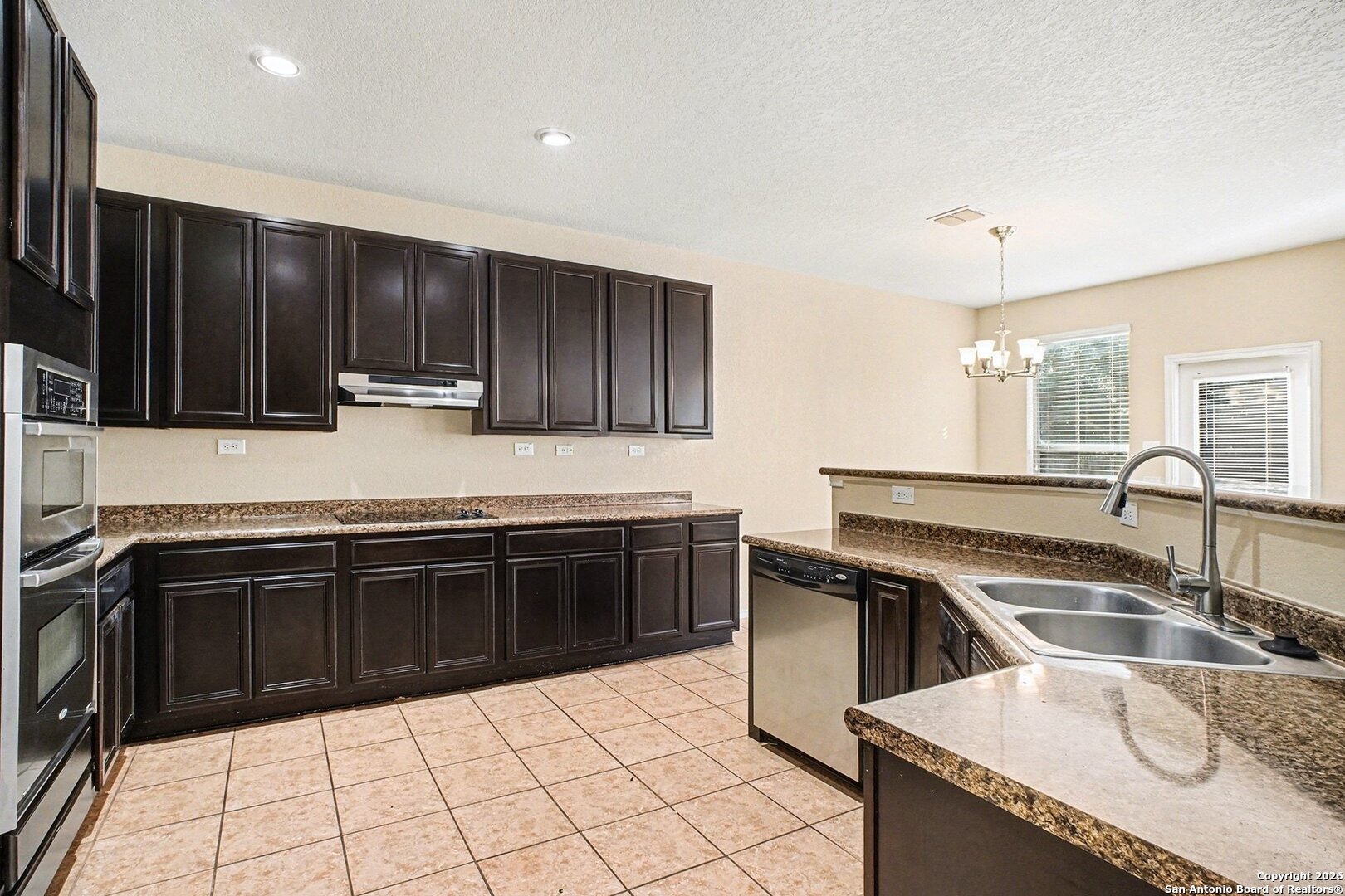 136 Prairie Falcon Boerne, TX 78006 - Photo 8 of 26 a kitchen with granite countertop a stove sink and cabinets