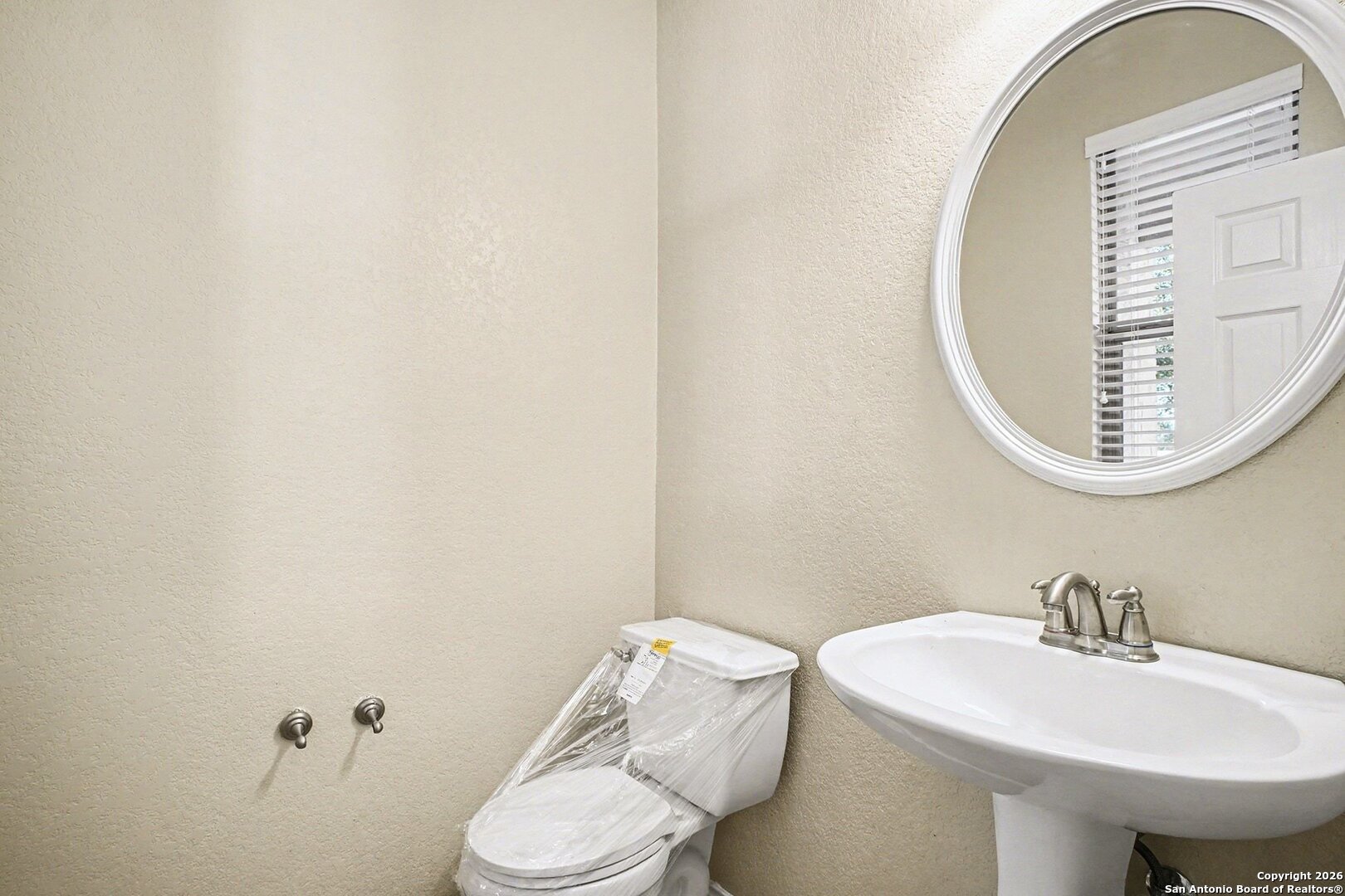 136 Prairie Falcon Boerne, TX 78006 - Photo 10 of 26 a bathroom with a sink mirror and toilet