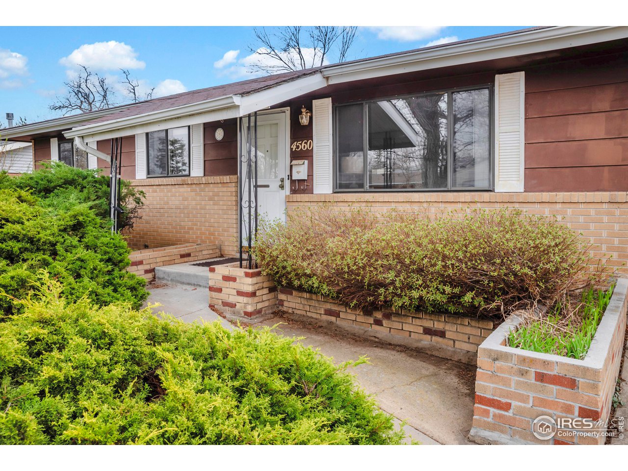 4560 Hanover Avenue Boulder, CO 80305 - Photo 3 of 27 a front view of a house with garden