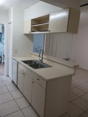 a kitchen with a sink and cabinets