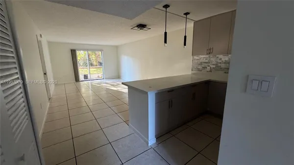 a kitchen with stainless steel appliances a sink and a refrigerator