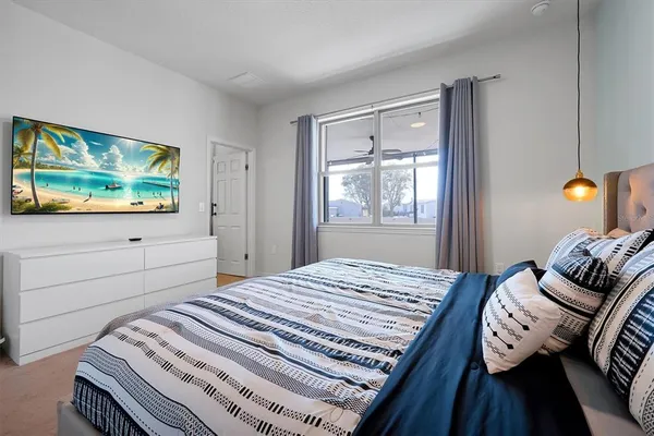 a bed sitting in a bedroom next to a bathroom