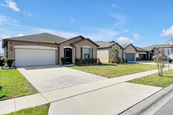 a front view of a house with a yard and garage