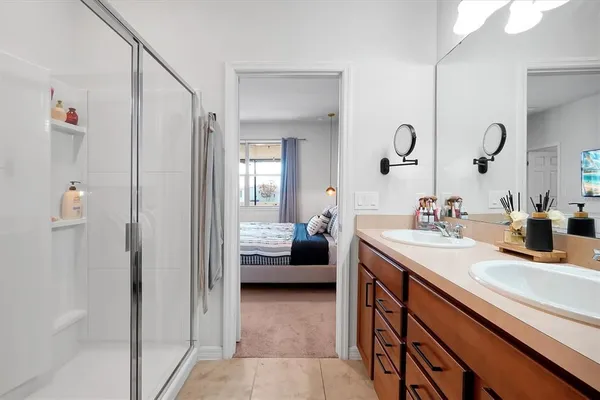 a en suite bathroom with a sink double vanity and a mirror