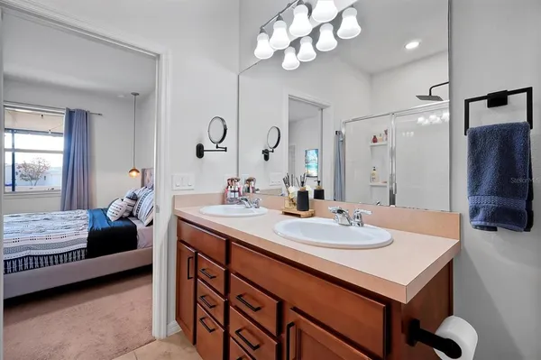 a bathroom with a sink vanity mirror and toilet