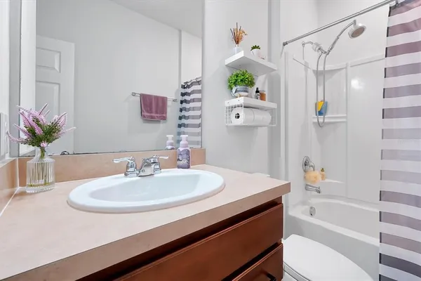 a bedroom with a bed couch and window