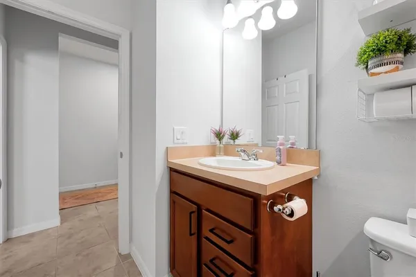 a bedroom with a bed and a lamp on table