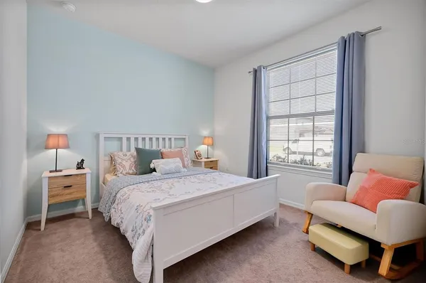 a bedroom with a bed and a lamp on table