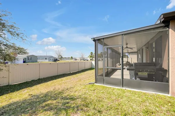 an aerial view of a house with yard swimming pool and ocean view