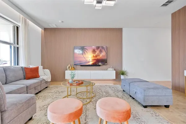 a living room with furniture and a flat screen tv