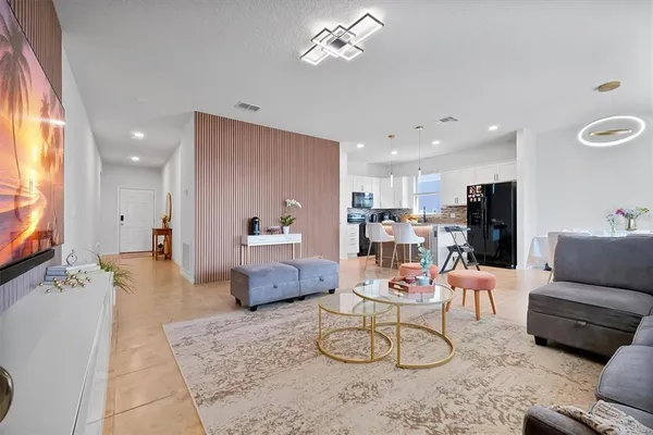 a living room with furniture and a flat screen tv
