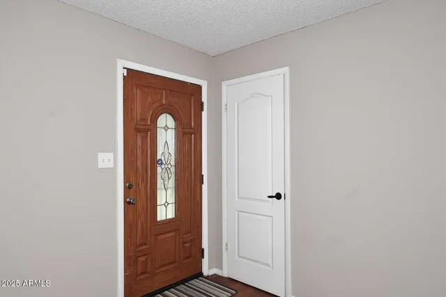a view of an entryway with wooden floor