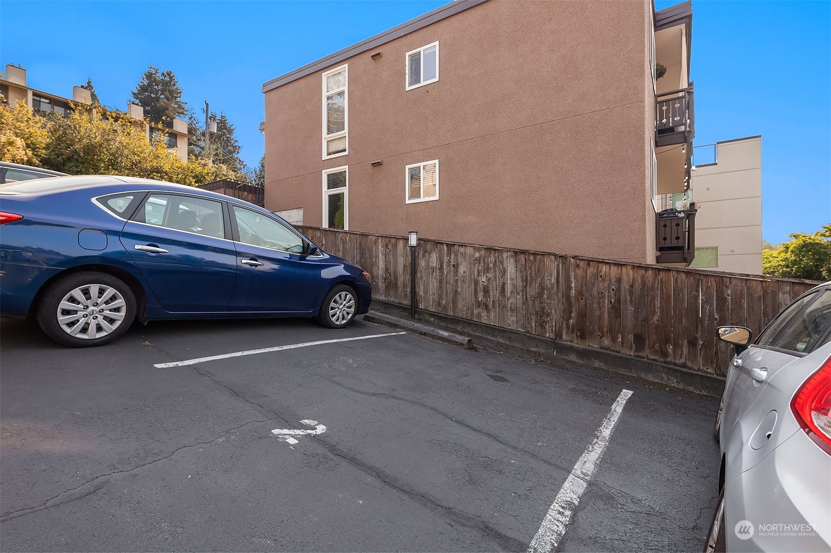 2034 14th Avenue West, Unit 302 Seattle, WA 98119 - Photo 11 of 12 a front view of a house with parking space