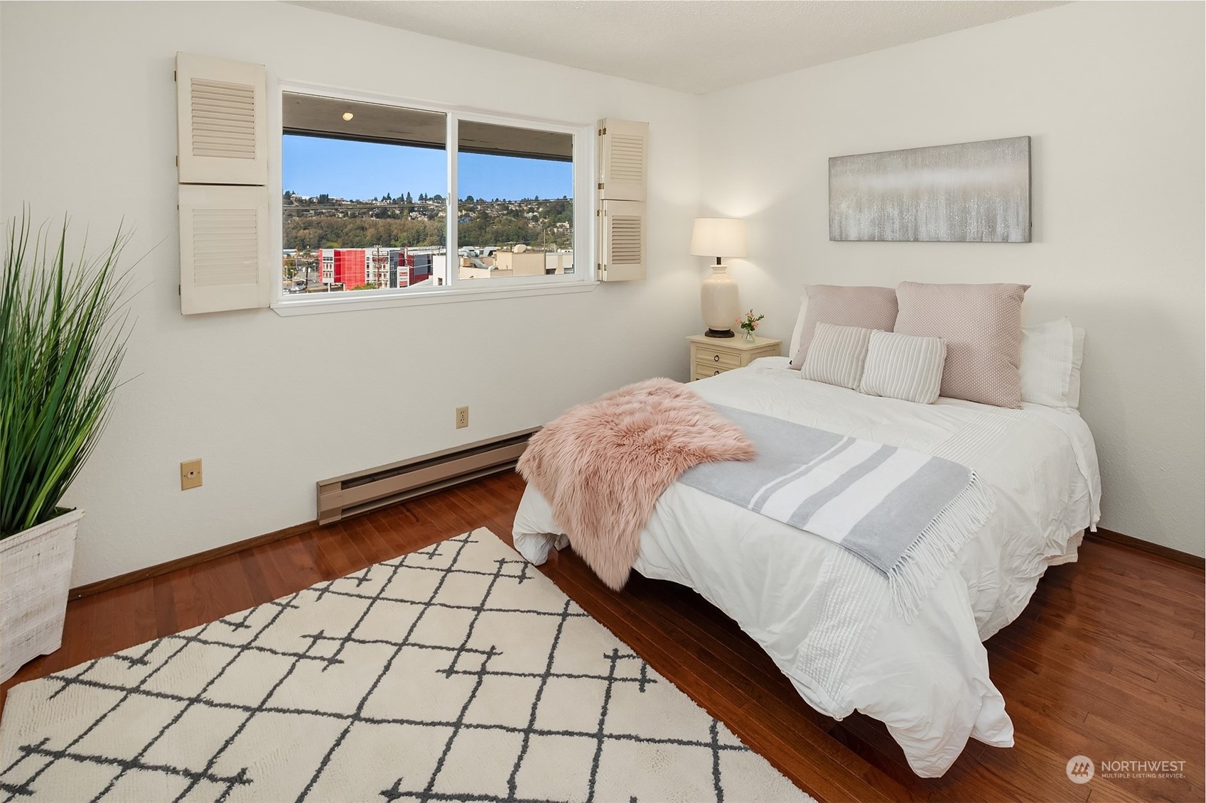 2034 14th Avenue West, Unit 302 Seattle, WA 98119 - Photo 9 of 12 a bedroom with a bed and a window