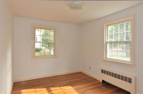 36 Arrowhead Road Concord, MA 01742 - Photo 11 of 14 a view of an empty room with wooden floor and a window