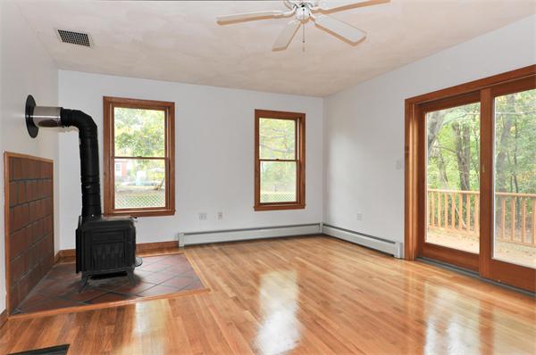 36 Arrowhead Road Concord, MA 01742 - Photo 4 of 14 a view of an empty room with a window and wooden floor