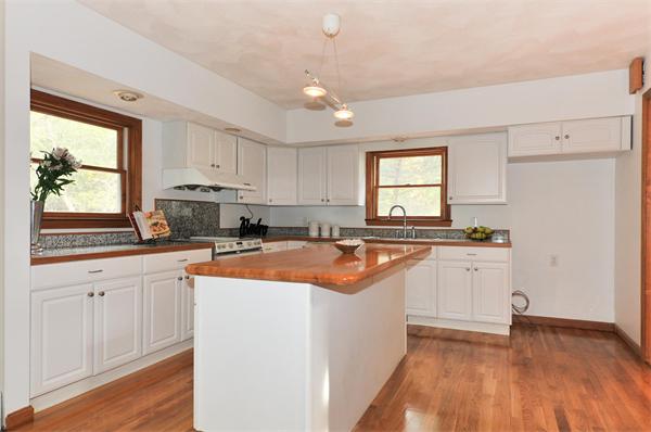 36 Arrowhead Road Concord, MA 01742 - Photo 5 of 14 a kitchen with stainless steel appliances granite countertop a sink a stove and a refrigerator