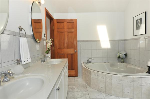 36 Arrowhead Road Concord, MA 01742 - Photo 8 of 14 a bathroom with a tub sink and mirror