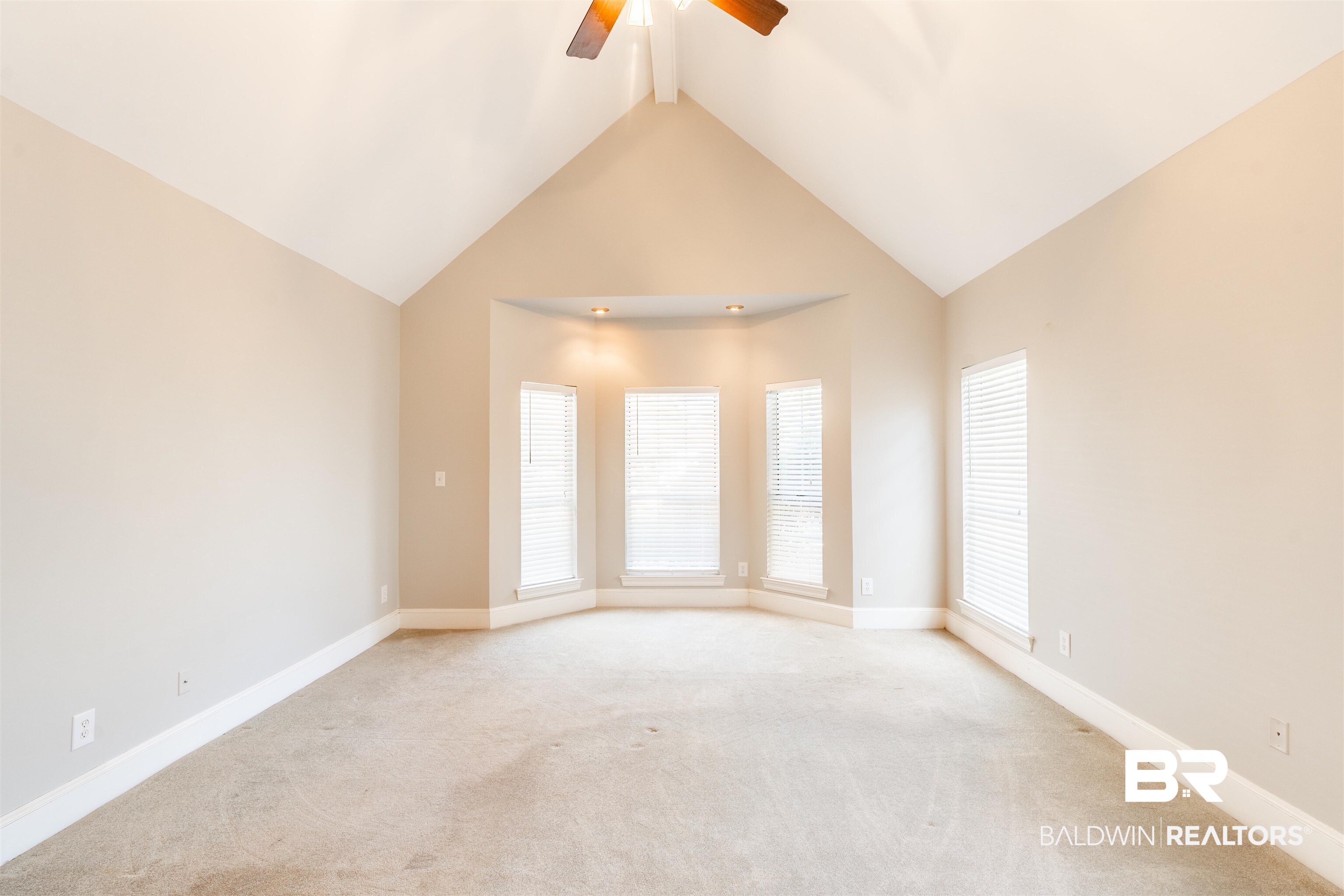 3821 St Andrews Loop East Mobile, AL 36693 - Photo 26 of 41 Spare room featuring light carpet, high vaulted ceiling, and ceiling fan
