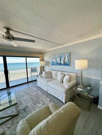 a living room with furniture and a lamp on table with wooden floor