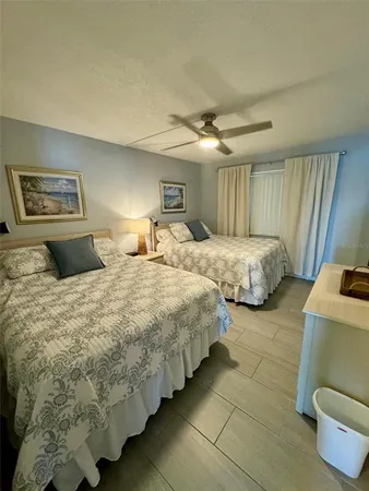 a spacious bedroom with two beds and painting on the wall