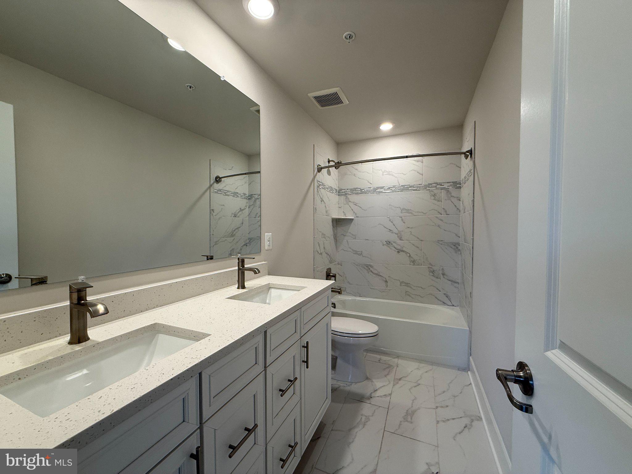 1407 Pinkerton Street Brunswick, MD 21716 - Photo 14 of 21 Sleek modern bathroom with marble accents.