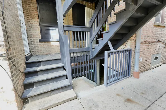 a view of entryway with wooden floor and stairs