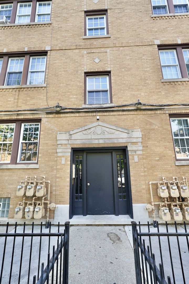 6707 South Artesian Avenue, Unit LL Chicago, IL 60629 - Photo 15 of 15 front view of a brick house with many windows