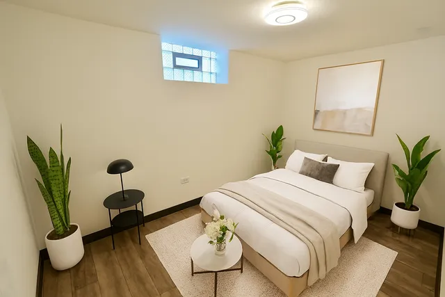 a bedroom with a bed and wooden floor