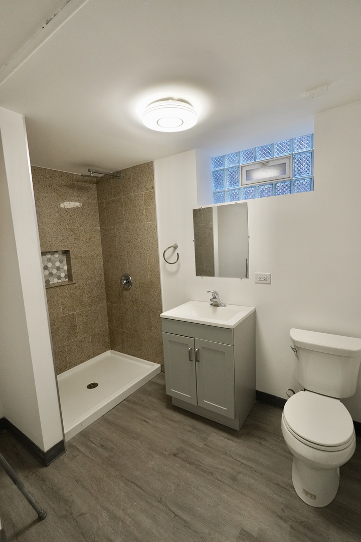 6707 South Artesian Avenue, Unit LL Chicago, IL 60629 - Photo 6 of 15 a bathroom with a sink a toilet and shower