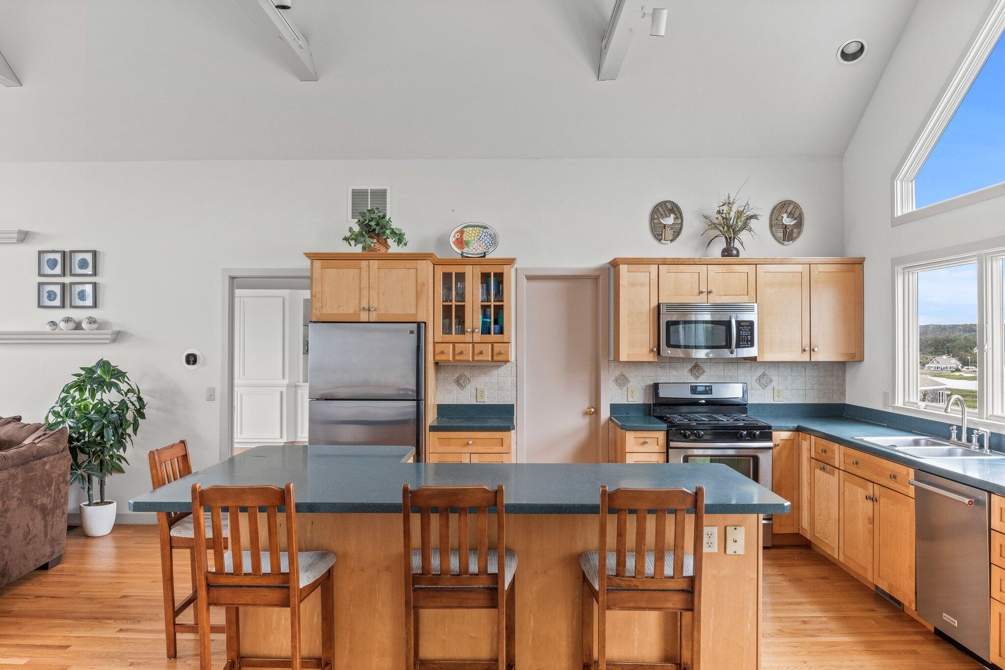 25 Great Hills Road Truro, MA 02666 - Photo 13 of 68 a kitchen with stainless steel appliances wooden floor dining table and chairs