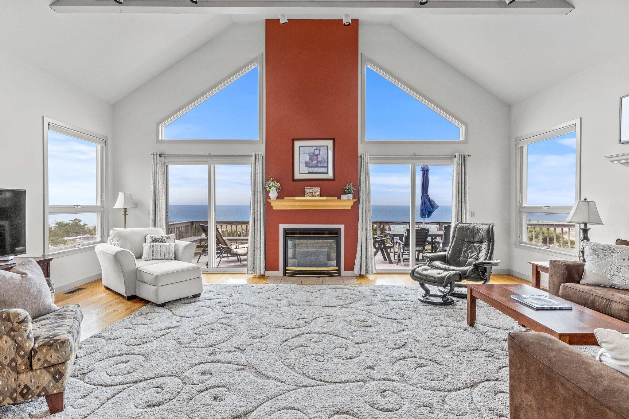 25 Great Hills Road Truro, MA 02666 - Photo 16 of 68 a living room with furniture large window and a fireplace