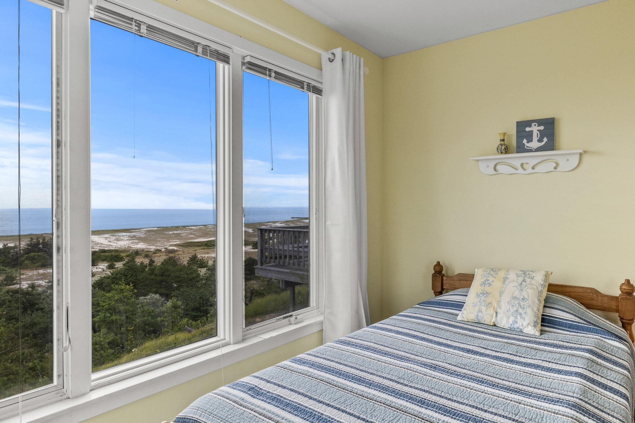 25 Great Hills Road Truro, MA 02666 - Photo 27 of 68 a bedroom with a bed and a view of outdoor space