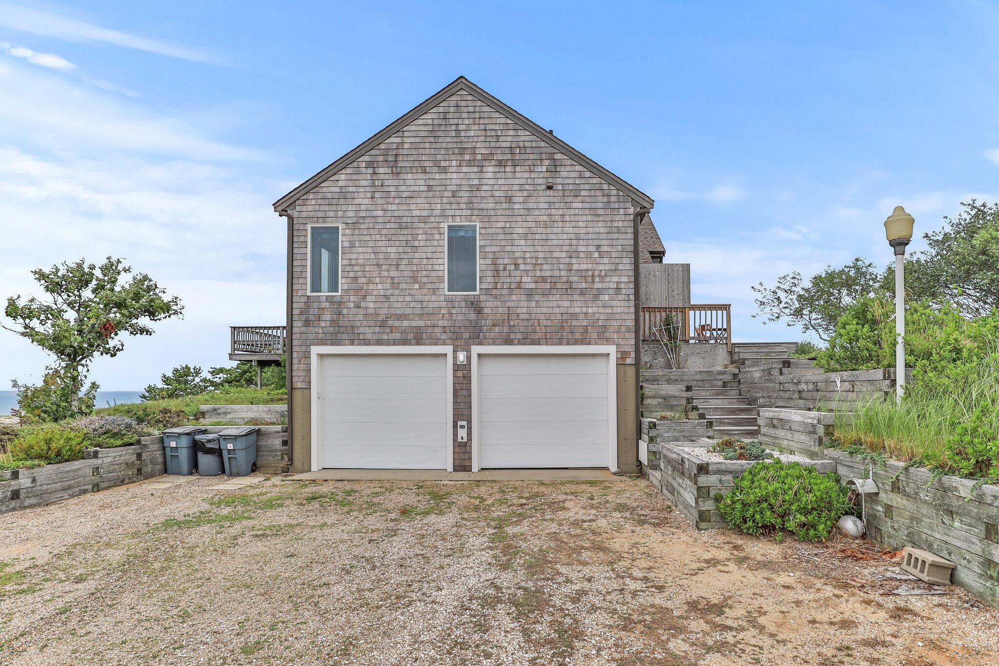 25 Great Hills Road Truro, MA 02666 - Photo 46 of 68 a front view of a house with a yard and garage